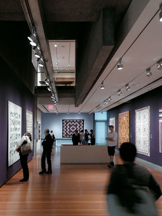 Exhibition spaces at the American Folk Art Museum utilise a rich palette – pre-cast and in-situ concrete hang frozen over the warm gallery floor.