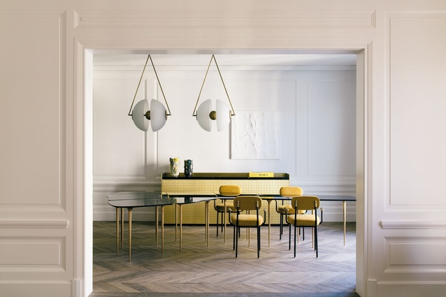 The dining room’s yellow and white colour palette is offset by the natural oak parquet flooring. 