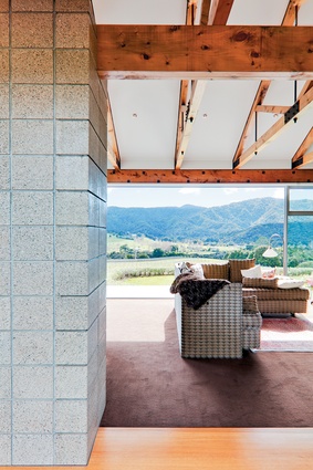 The interior palette features exposed macrocarpa beams and concrete block. 