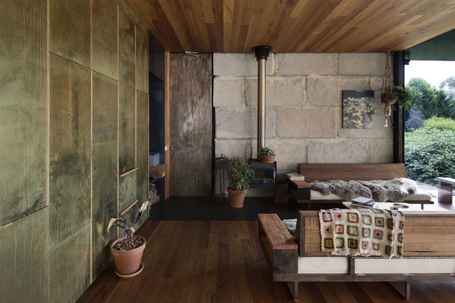 Inside, a mix of brass, timber and overscale blocks of concrete combine with bespoke furniture. 