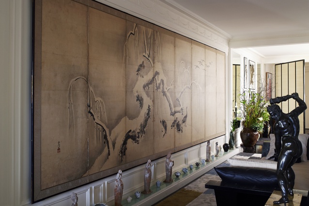 Panelled artwork spans one of the apartment walls. 
