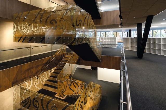 The central mass timber stair acts as a vertical connector, introducing natural light to lower levels while reducing the building’s embodied carbon.