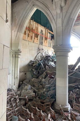 Debris against the west wall of the nave prior to clearance by remote excavator.