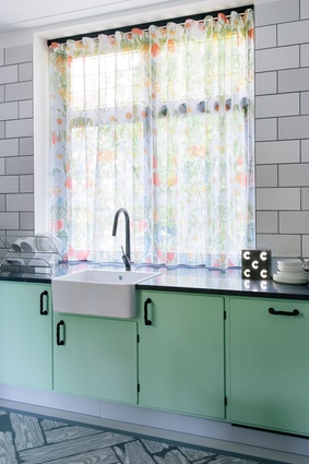 Gauzy curtains in the studio’s Withered Flowers design soften the kitchen windows.