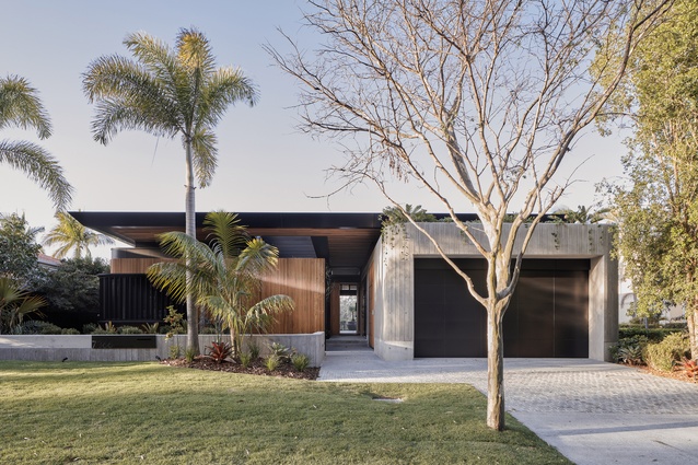 The design of the house is broken into three components – concrete walls, timber screens and a floating roof line.