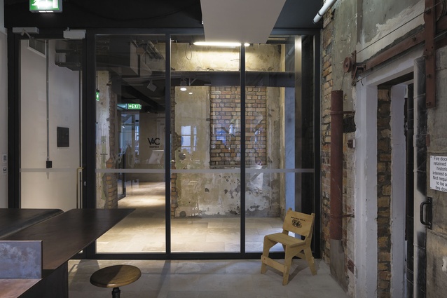 View from reception to entrance way and an unusual rectangle of exposed brick.