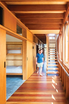 The breezeway connecting all the rooms features decking boards and open timber framing.