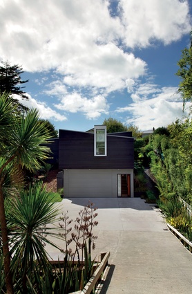 The site gets all-day sun, creating a light-filled home that works with its steep location.