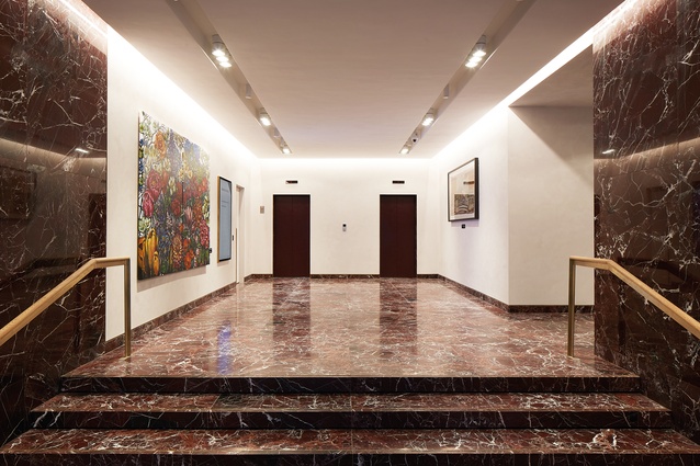 The new lobby space is classic with a twist – the richly veined red marble stealing the show.