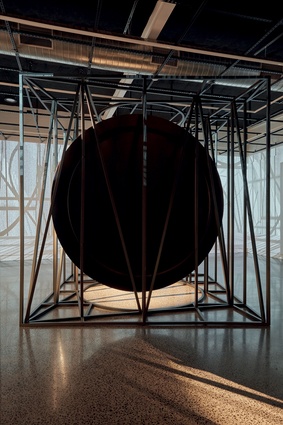 The exhibit comprises a stainless-steel mirror inside an aluminium skeleton frame – a cage-like cube which is animated by moving projections of simulations of the frame and mirror.