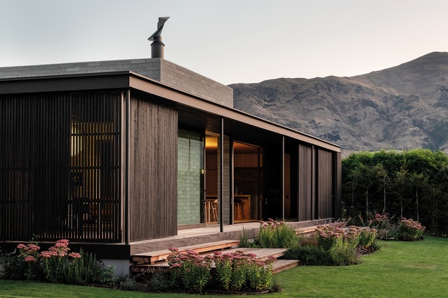 Charred timber screens open onto the north-facing rear garden.