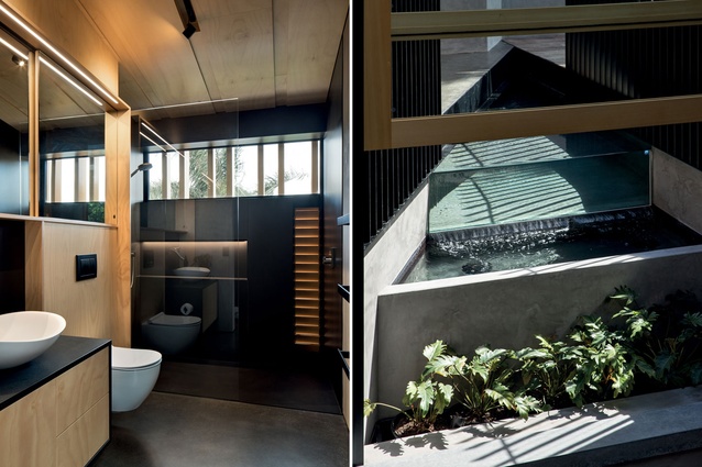 A sleek and minimal bathroom; the wedge-shaped water feature has a glass infinity edge.