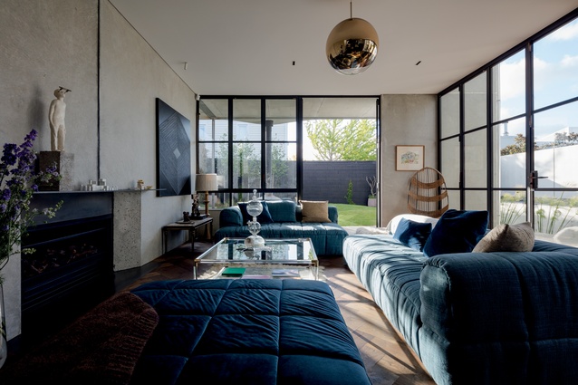 The living area contains a Strip Sofa (1972) by Cini Boeri for Arflex. 
