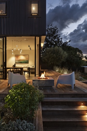 A private deck space flows out from the living room of the main dwelling.