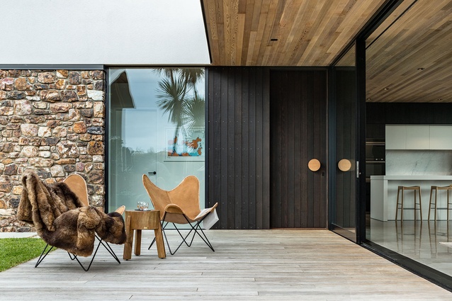 The contrasting dark stained cedar and local rock reflect the surrounding natural environment.