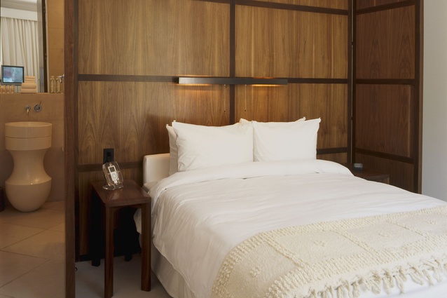 Wood panelling in rooms serves as acoustic barriers and swivels to act as doors and partitions. 