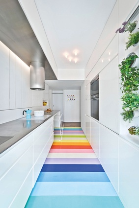 Linoleum and rubber flooring: The rainbow-striped rubber floor inside a Paris apartment by Sabo Project contrasts against the rest of the stark-white interior.