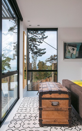 The guest bedroom, which overlooks the section, has fantastic views of Enclosure Bay from the floor-to-ceiling windows.