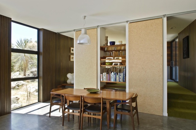 Sliding panels separate the dining area from the lounge, creating a self-contained snug as needed in the Drift Bay house. 