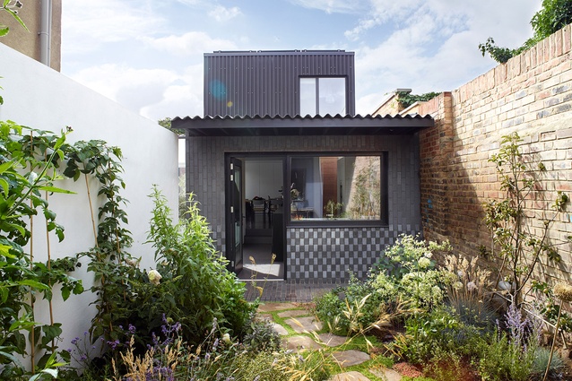 Courtyard House by Dallas Pierce Quintero in London. Built on a tiny infill plot, this home features dark, almost-blue brick, that forms unusual vertical stripes.