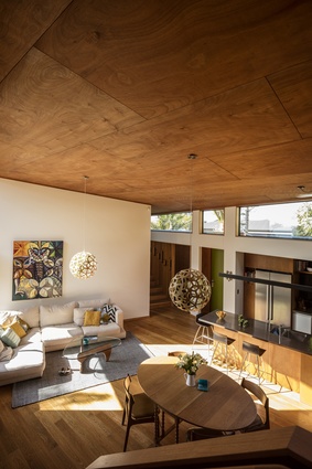 Tawini House interior. The large, single protecting roof plane is lined with warm plywood and creates a sense of containment and enclosure.