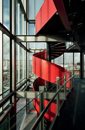 A vivid red spiral staircase carries patrons up to the first level.
