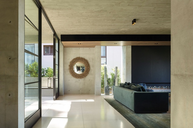 The timber-grain concrete ceiling, polished terrazzo floor and smooth concrete walls bring texture and detail to the living spaces.