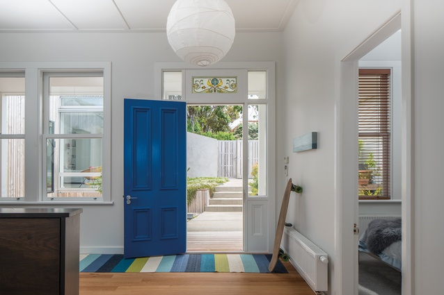 The blue front door adds a splash of colour, along with the stained-glass panel above.
