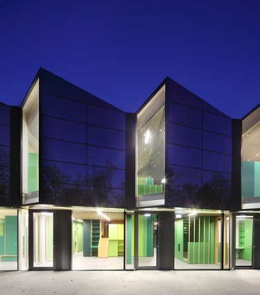Nursery +E, Germany. The building features a striking folded glass exterior and is designed as a surplus energy house.