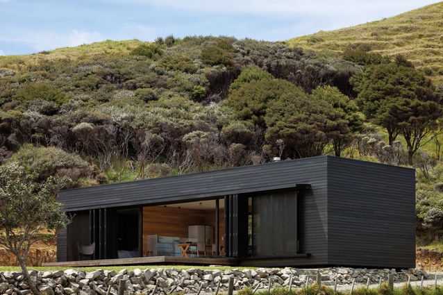 Storm Cottage: The dark exterior palette is completed with a layer of operable screens.
