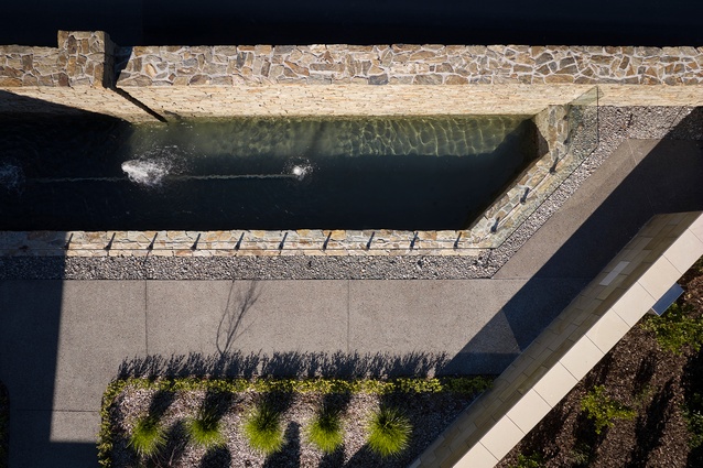 Landscaping by Sanderson Group complements the adjacent bridge and pond, also designed by Turner Road Architects.