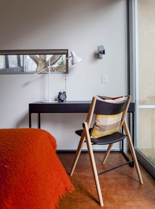 A BoConcept desk and chair take up a sunny spot in the guest room. 