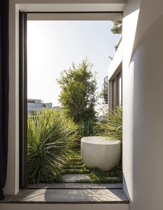 An outdoor bath sitting in the garden can be accessed from the en suite. 