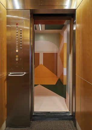 An Esther Stewart mural covers the walls and ceiling in the entry from the lift.
