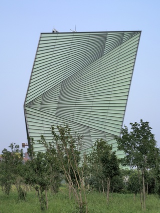 The Centre for Sustainable Energy Technology (CSET) in Ningbo, China. The building is covered with a double skin of glass and includes a rooftop opening for natural ventilation.
