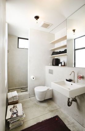 The bathroom features muted tones. 
