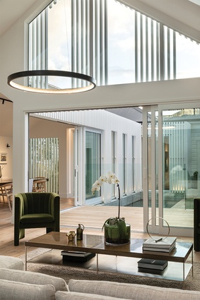 Cameron Design House Lahti circular pendant, imported from the UK softens the height of this space.