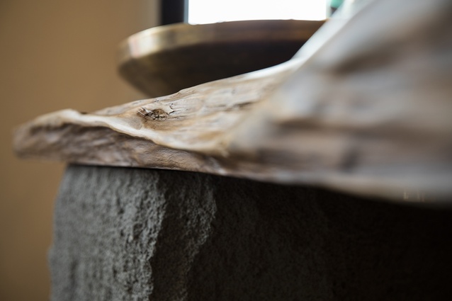 A large slab of 150-year-old Kauri river wood from Northland marks a strong connection to nature. It is positioned on a Timaru bluestone base.