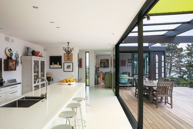 The Box Living home is filled with colourful artworks. In the kitchen, white rubber flooring from the USA was installed.