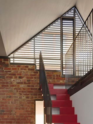 Maynard's Vader House in Melbourne. Bright red tiles are contrasted against the warm brick, glass tiles and joinery.