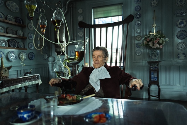 Willem Dafoe as Godwin Baxter, in his home. Note his face and medical apparatus.
