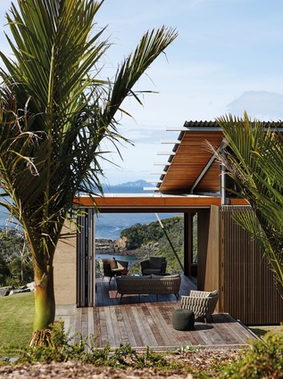 The lanai opens up on three sides to become a gateway to the view: grass on one side and deck on the other.