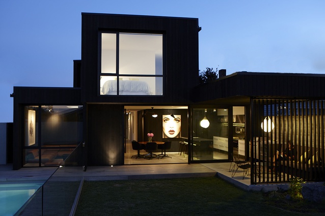 The simple, sheltered outdoor area is a continuation of the kitchen, with the cabinetry transitioning into the barbecue surround. 