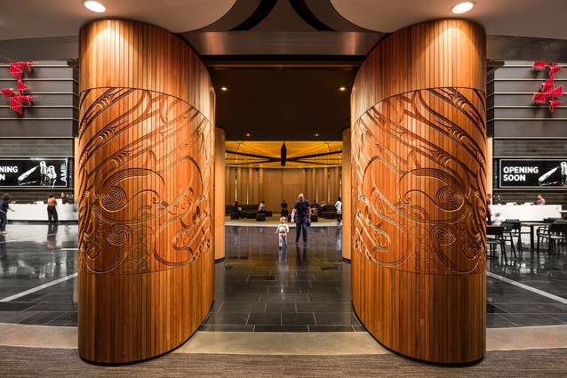 The shallow-relief <em>Te Tatau Kaitiaki</em>, designed by Graham Tipene, forms the entry gate into Te Ao Mārama atrium and can be opened or closed.