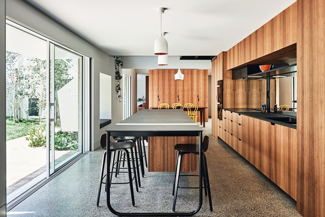Neat, timber-lined joinery gives order and functionality to the dining room and kitchen spaces.