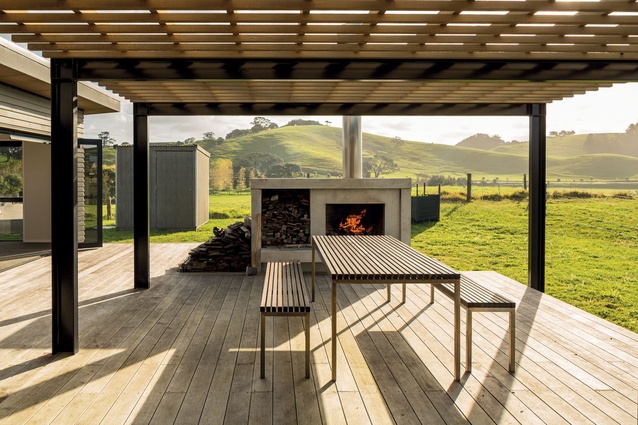 To the rear of the property is the large dining deck. The pergola offers shade from the afternoon sun, while the open fireplace extends the usage of the space to year round. 