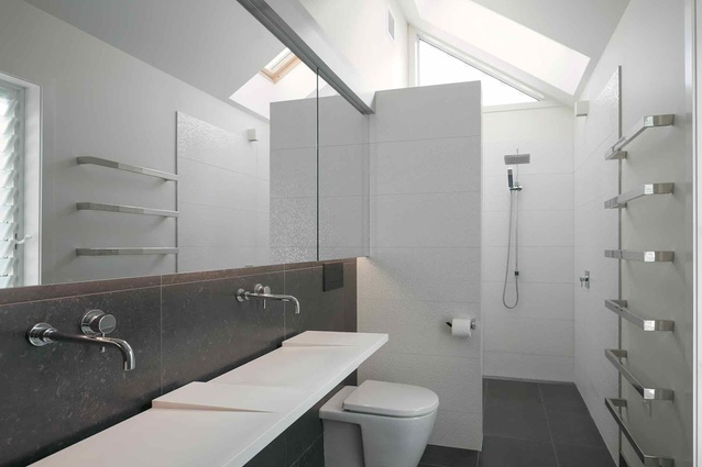 The ensuite bathroom features a slim and sleek washplane. 