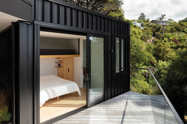 Warm timber interior notes are juxtaposed with the dark tin cladding.