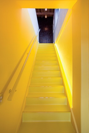 The entrance stairway is announced using a bright, bespoke Resene Yellow (RAL 1018).