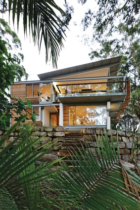 Avoca Beach, New South Wales. Architecture Saville Isaacs designed this home in 2014. The two-storeyed residence seems to disappear into the bush.